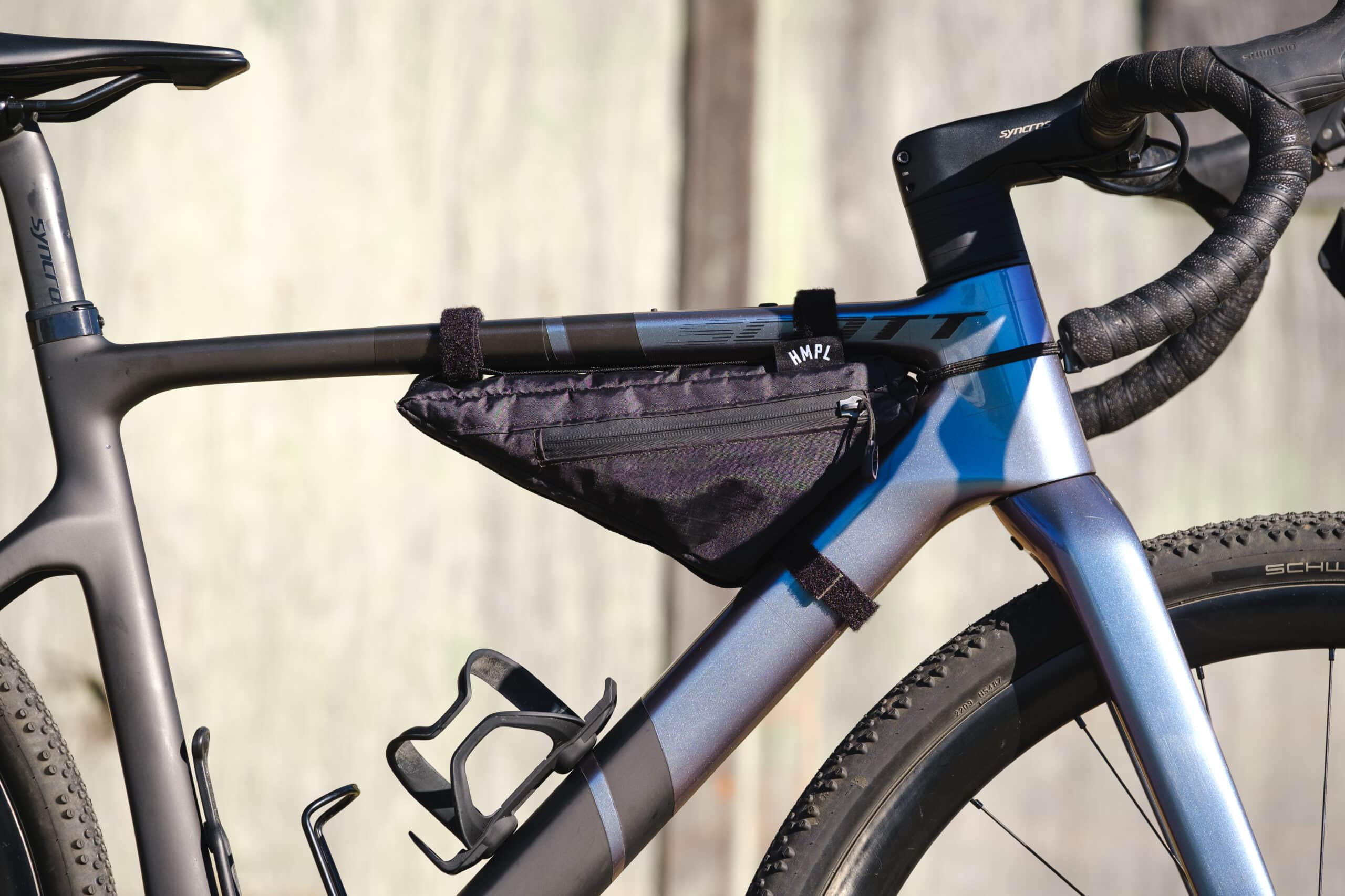 The matte metallic purple and grey Scott frame catching the sunlight perfectly. 